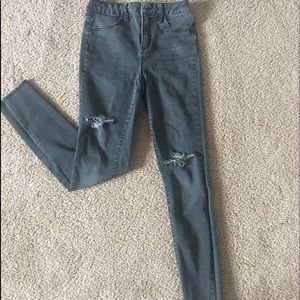 extra high rise. grey ripped jeans. used.
